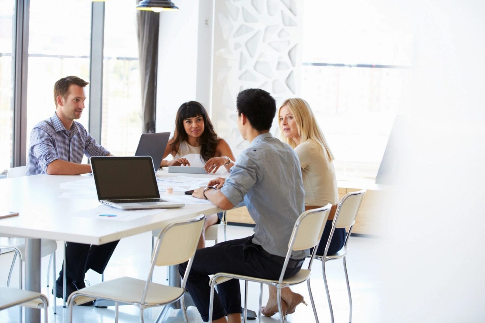 A group of people sitting around a table.